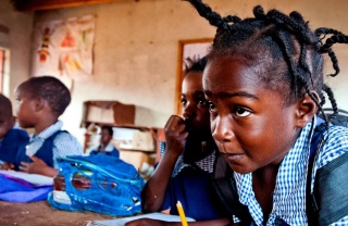 Une jeune fille concentrée alors qu'elle prend des notes en classe.