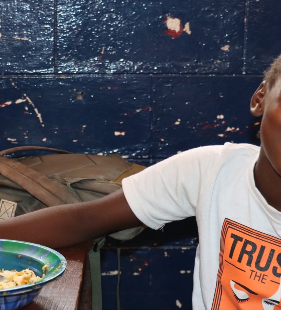 Girl eating Mary's Meals in Liberia
