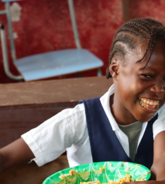 Girl eating Mary's Meals in Liberia